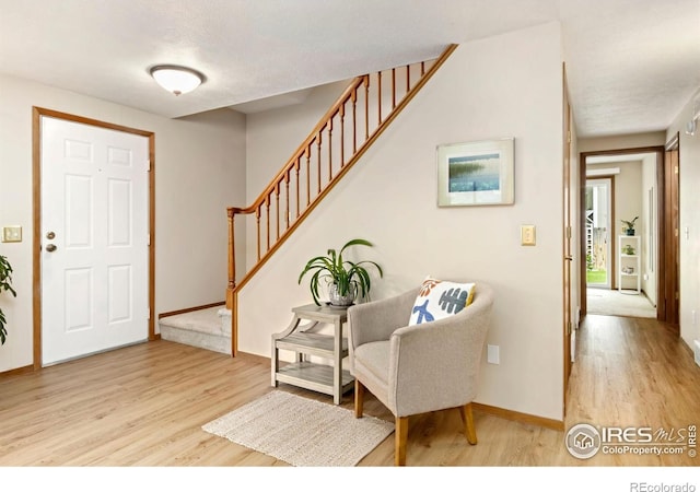 3301 Downing Ct, Fort Collins, CO 80526 - foyer entrance with light wood-style floors, stairway, and baseboards