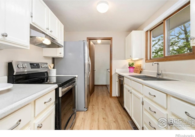 3301 Downing Ct, Fort Collins, CO 80526 - kitchen with stainless steel appliances, under cabinet range hood, light wood-style flooring, a sink, and light countertops