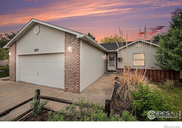 209 N 44th Avenue Ct, Greeley, CO 80634 - ranch-style home featuring brick siding, concrete driveway, and an attached garage