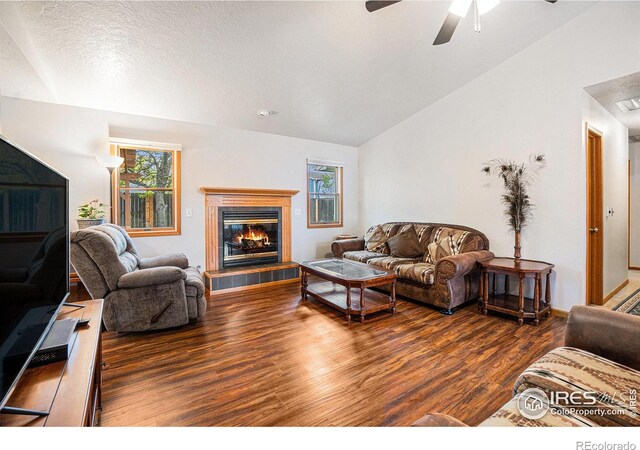209 N 44th Avenue Ct, Greeley, CO 80634 - living area featuring wood finished floors, vaulted ceiling, plenty of natural light, and ceiling fan
