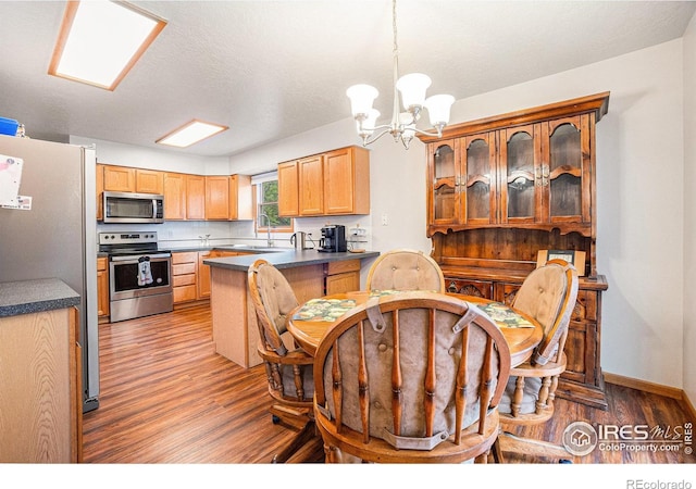 209 N 44th Avenue Ct, Greeley, CO 80634 - dining room featuring light wood finished floors and a chandelier