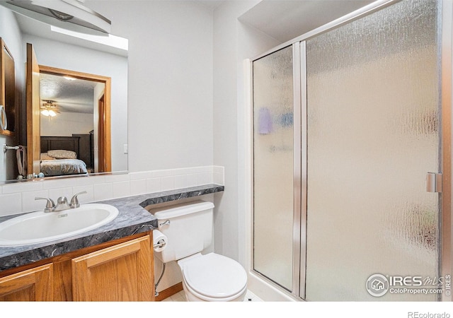 209 N 44th Avenue Ct, Greeley, CO 80634 - ensuite bathroom with a shower stall, vanity, toilet, and backsplash