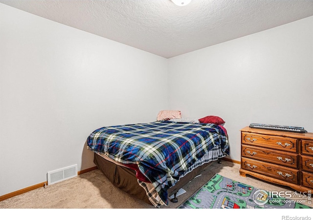 209 N 44th Avenue Ct, Greeley, CO 80634 - carpeted bedroom with baseboards and a textured ceiling