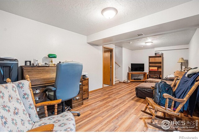 209 N 44th Avenue Ct, Greeley, CO 80634 - home office featuring wood finished floors and a textured ceiling