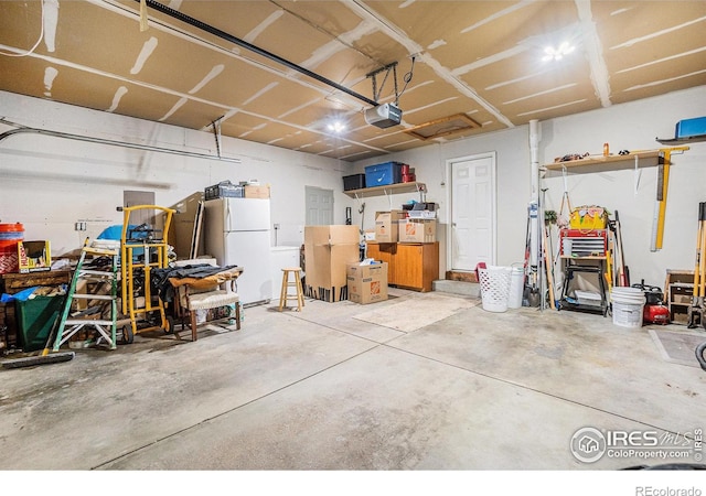 209 N 44th Avenue Ct, Greeley, CO 80634 - garage featuring freestanding refrigerator and a garage door opener