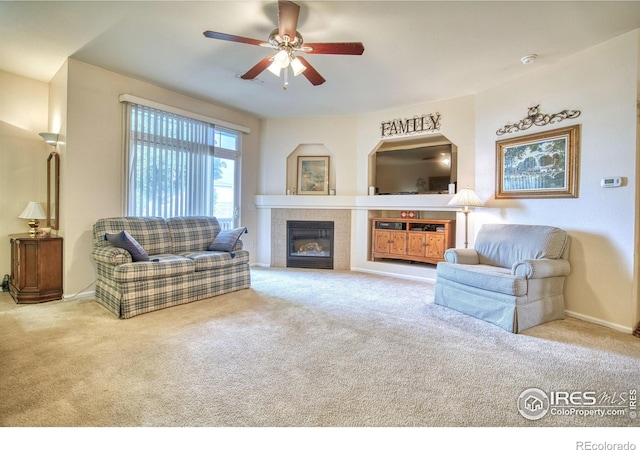 10818 Cimarron St Unit 1203, Firestone, CO 80504 - carpeted living room with ceiling fan, a tile fireplace, and baseboards