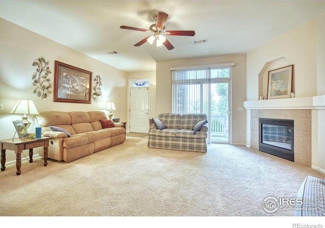 10818 Cimarron St Unit 1203, Firestone, CO 80504 - living area featuring carpet flooring, a tile fireplace, ceiling fan, and baseboards