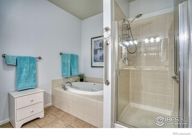 10818 Cimarron St Unit 1203, Firestone, CO 80504 - bathroom with a shower stall, tile patterned flooring, a garden tub, and baseboards