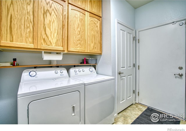 10818 Cimarron St Unit 1203, Firestone, CO 80504 - laundry area with washing machine and dryer, cabinet space, and light tile patterned flooring