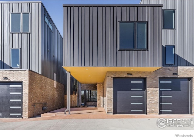 3335 Broadway St, Boulder, CO 80304 - modern home featuring board and batten siding, brick siding, and an attached garage
