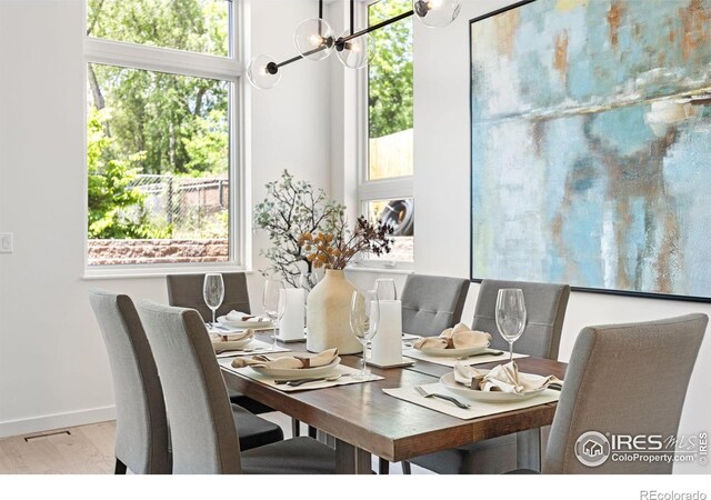 3335 Broadway St, Boulder, CO 80304 - dining area featuring wood finished floors, a chandelier, and baseboards