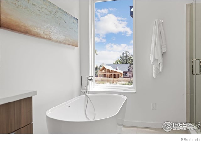 3335 Broadway St, Boulder, CO 80304 - bathroom featuring a freestanding bath, baseboards, vanity, and tile patterned flooring