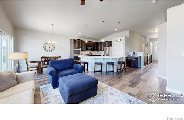 1384 Copeland Falls Rd, Severance, CO 80550 - living area with lofted ceiling, light wood-style floors, baseboards, a chandelier, and ceiling fan