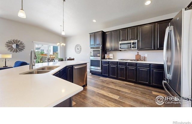 1384 Copeland Falls Rd, Severance, CO 80550 - kitchen featuring stainless steel appliances, a sink, a chandelier, lofted ceiling, and light countertops