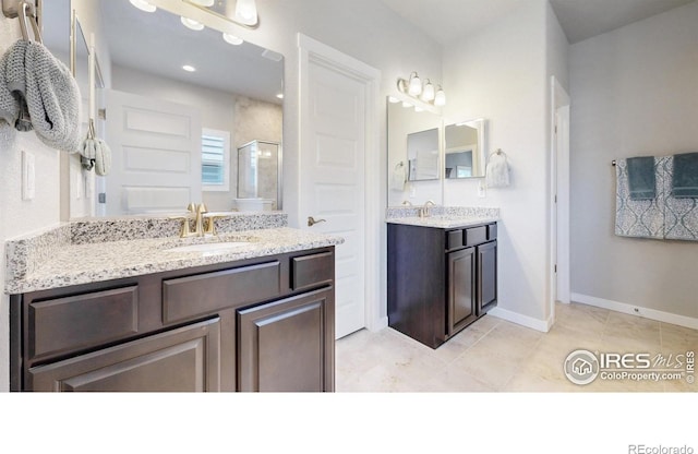 1384 Copeland Falls Rd, Severance, CO 80550 - bathroom with a shower stall, two vanities, tile patterned floors, and baseboards