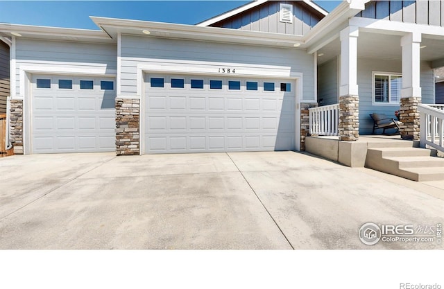 1384 Copeland Falls Rd, Severance, CO 80550 - view of front of house with stone siding, a garage, board and batten siding, and driveway