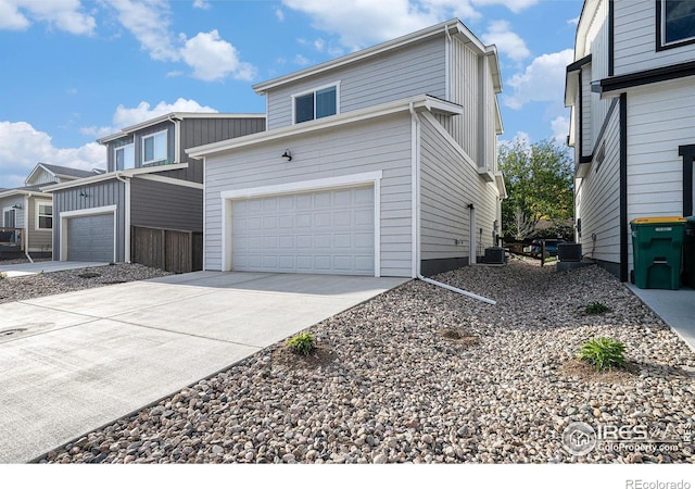 1099 Spartan Ave, Berthoud, CO 80513 - view of front of property with driveway, a garage, and cooling unit