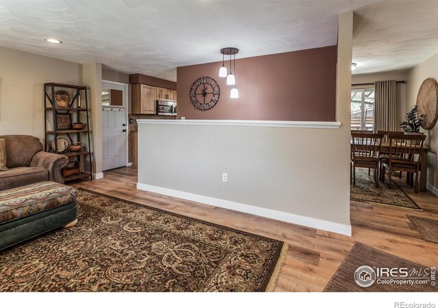 501 Copeland Way, Longmont, CO 80504 - living area featuring baseboards, light wood finished floors, and recessed lighting
