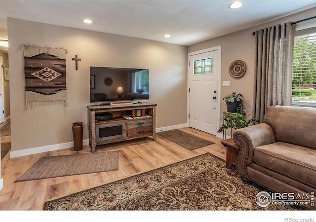 501 Copeland Way, Longmont, CO 80504 - living area featuring wood finished floors, baseboards, and recessed lighting