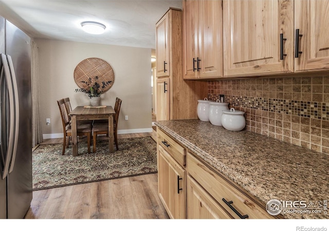 501 Copeland Way, Longmont, CO 80504 - kitchen featuring freestanding refrigerator, light wood-type flooring, tasteful backsplash, and light brown cabinetry