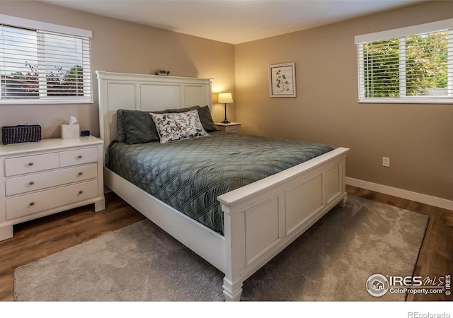 501 Copeland Way, Longmont, CO 80504 - bedroom featuring dark wood finished floors and baseboards