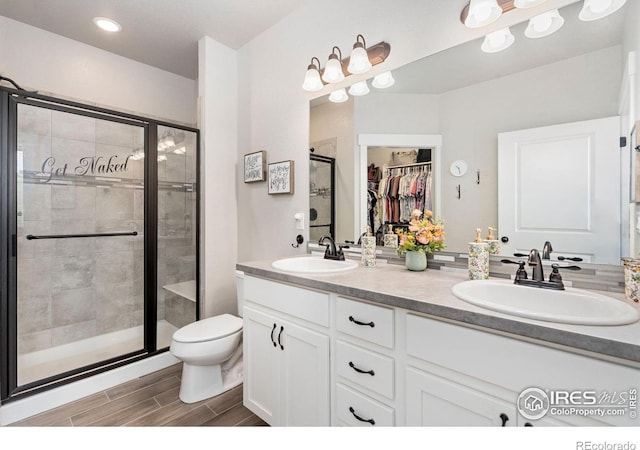 2751 Iowa Dr Unit 205, Fort Collins, CO 80525 - full bathroom with a shower stall, double vanity, a walk in closet, and recessed lighting