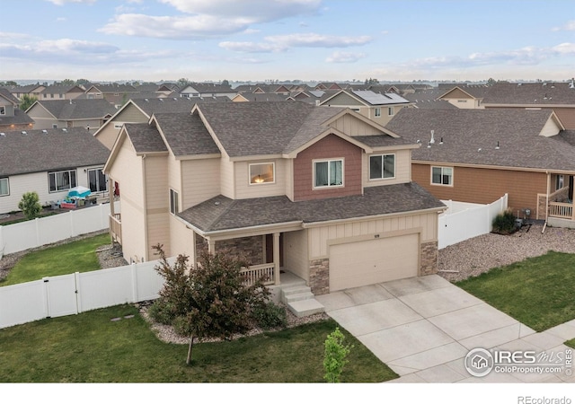 978 Mouflon Dr, Severance, CO 80550 - view of property with a residential view, stone siding, a garage, and concrete driveway