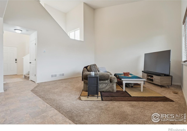 978 Mouflon Dr, Severance, CO 80550 - carpeted living room featuring a towering ceiling and baseboards