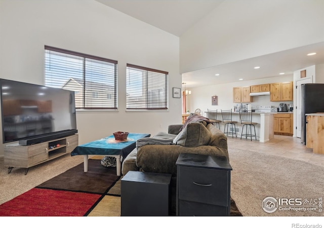 978 Mouflon Dr, Severance, CO 80550 - living area with recessed lighting, a high ceiling, and light colored carpet