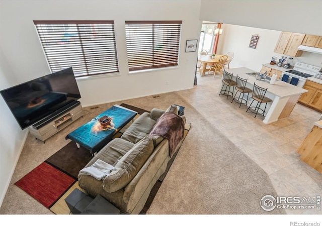 978 Mouflon Dr, Severance, CO 80550 - living room with a chandelier and light carpet
