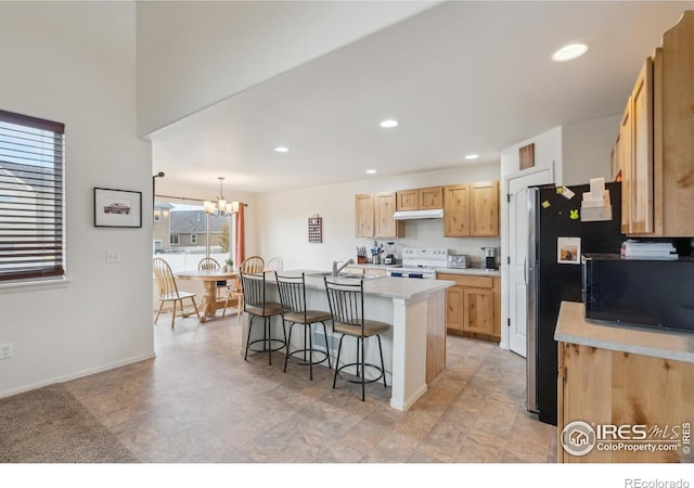 978 Mouflon Dr, Severance, CO 80550 - kitchen with white range with electric cooktop, black microwave, light countertops, a kitchen breakfast bar, and recessed lighting