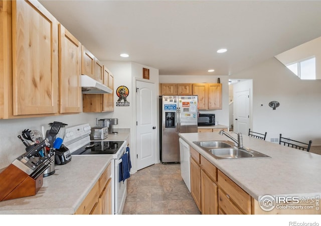 978 Mouflon Dr, Severance, CO 80550 - kitchen with white appliances, a sink, under cabinet range hood, light brown cabinets, and recessed lighting
