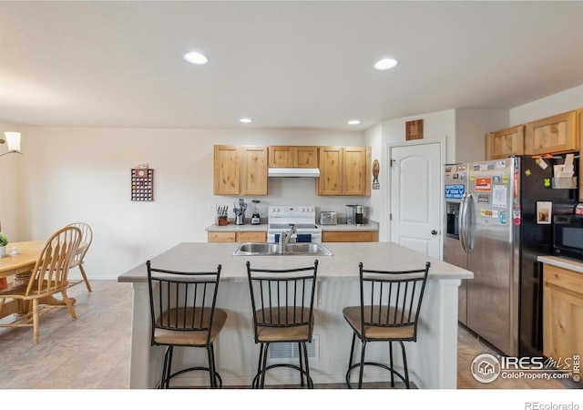 978 Mouflon Dr, Severance, CO 80550 - kitchen featuring stainless steel refrigerator with ice dispenser, under cabinet range hood, white electric range oven, a sink, and a center island with sink