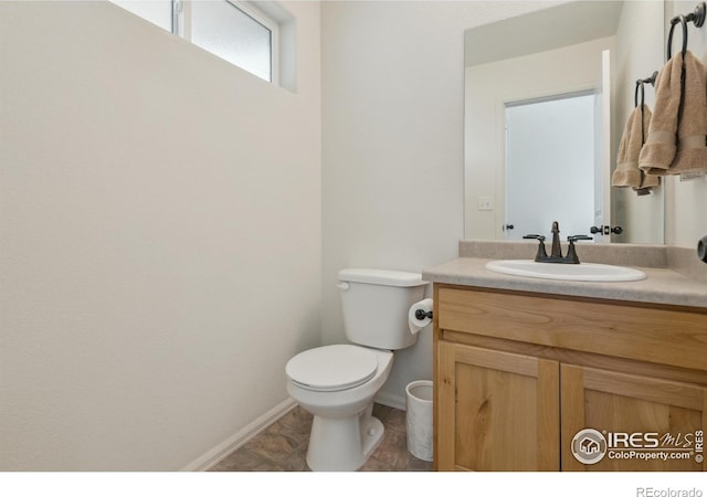 978 Mouflon Dr, Severance, CO 80550 - bathroom with toilet, vanity, and baseboards