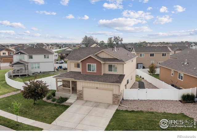 978 Mouflon Dr, Severance, CO 80550 - view of front of house featuring a residential view, driveway, roof with shingles, board and batten siding, and stone siding