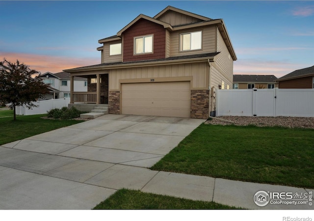 978 Mouflon Dr, Severance, CO 80550 - view of front of property featuring board and batten siding, stone siding, an attached garage, driveway, and a porch