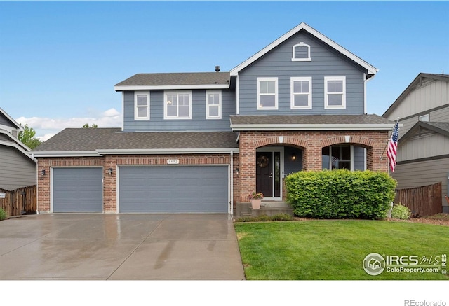 6492 Richland Ave, Timnath, CO 80547 - view of front of property featuring brick siding, roof with shingles, driveway, and an attached garage