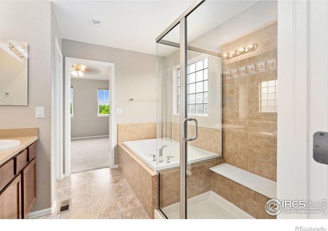 6492 Richland Ave, Timnath, CO 80547 - bathroom with vanity, a bath, a stall shower, baseboards, and ceiling fan