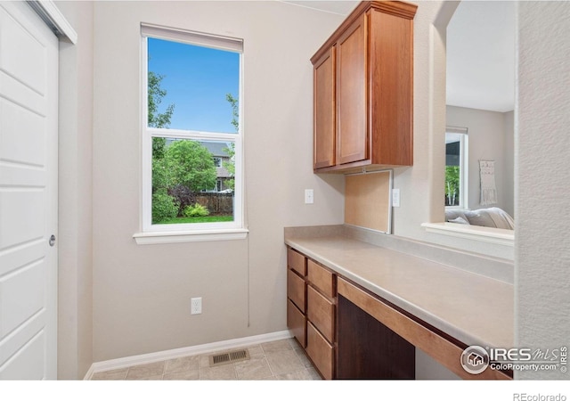 6492 Richland Ave, Timnath, CO 80547 - kitchen with brown cabinets, light countertops, and baseboards