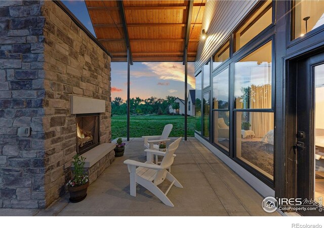 1563 Spring Creek Xing, Lafayette, CO 80026 - view of patio featuring an outdoor stone fireplace