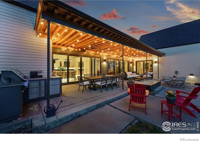 1563 Spring Creek Xing, Lafayette, CO 80026 - patio terrace at dusk featuring outdoor dining area, a patio area, and an outdoor hangout area