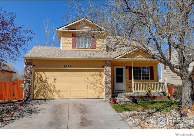 5241 E 128th Way, Thornton, CO 80241 - view of front of house featuring covered porch, concrete driveway, and roof with shingles