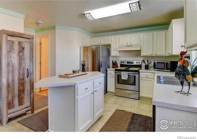 5241 E 128th Way, Thornton, CO 80241 - kitchen with appliances with stainless steel finishes, light countertops, under cabinet range hood, ornamental molding, and a center island