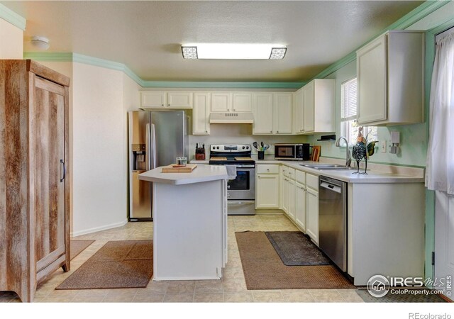 5241 E 128th Way, Thornton, CO 80241 - kitchen with stainless steel appliances, a sink, light countertops, under cabinet range hood, and a center island