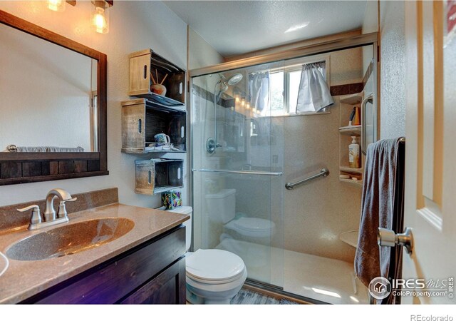 5241 E 128th Way, Thornton, CO 80241 - full bath featuring toilet, vanity, and a shower stall