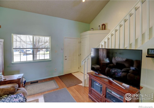 5241 E 128th Way, Thornton, CO 80241 - entrance foyer featuring light wood-style floors, stairway, and lofted ceiling