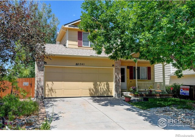 5241 E 128th Way, Thornton, CO 80241 - view of front of home with covered porch, concrete driveway, and roof with shingles