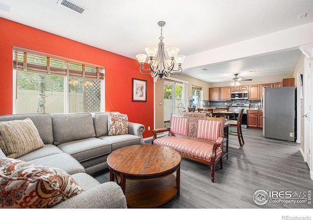 18656 Kelly Pl, Denver, CO 80249 - living room with a chandelier, light wood-style flooring, baseboards, and ceiling fan