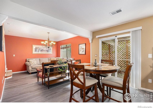 18656 Kelly Pl, Denver, CO 80249 - dining room with wood finished floors, baseboards, a chandelier, and beam ceiling