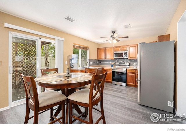 18656 Kelly Pl, Denver, CO 80249 - dining space with light wood finished floors and a ceiling fan